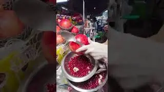 Thai vendor makes fresh pomegranate juice