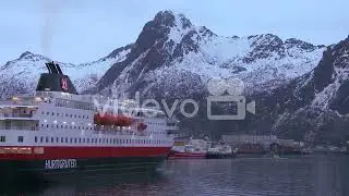 The cruise ship Hurtigruten sails through the fjords of Norway to arrive at Svolvaer in the Lofoten