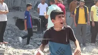 Palestinians survey rubble left in aftermath of Israeli strike on Deir al-Balah in central Gaza