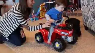 Riding a Power Wheels kawasaki lil' quad