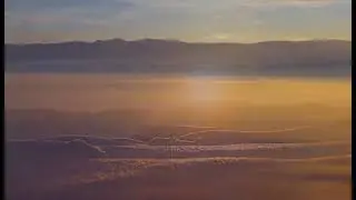 The mountains are standing above the clouds while the lake is covered in a thick blanket of fog
