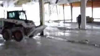 Bobcat 763 pushing a plaster pile