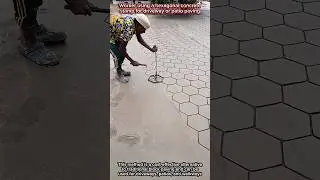 Worker Using a Hexagonal Concrete Stamp for Driveway or Patio Paving