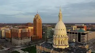Michigan's State Capitol Building and downtown Lansing at sunset.
