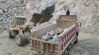 Caterpillar 966E in Action at Mining Site: Loading Huge Rocks into Dump Trucks & Trolleys