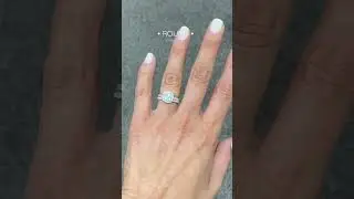 Round engagement ring in a cushion halo and matching wedding band