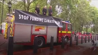 Climate change activists spray red paint at UK Treasury building