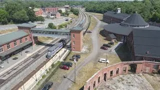 Amtrak 164 leads Capitol Limited 30 at Martinsburg WV Roundhouse. Drone view.