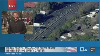 Crowd gathers outside The Carter Center, awaiting Jimmy Carter motorcade's arrival
