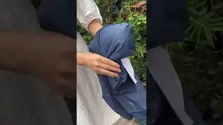 How do I put my rain jacket in my hand pocket?
