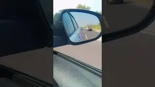 Car Running On The Road Mirror View..