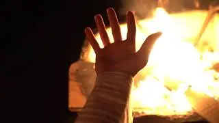 Man doing rituals in front of Bonfire.