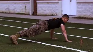 U.S. Marine Corps Force Fitness Instructor trainers demonstrate the Wide Base Push-Up