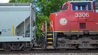CN EJ&E 3023, 3306 move an Eastbound train with BN hoppers, BC RAIL gondola past Vicksburg, MI