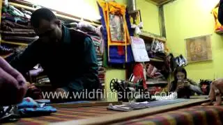 Indian Tailor irons a newly stitched salwar suit