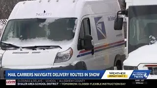 Mail carriers navigate delivery routes in the snow