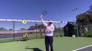 Best way to learn a topspin serve hit up up and up as high as you can over the net by Rick Macci