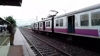 Purple And Pink Colour Emu Local Train Crossing Station.