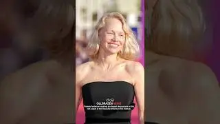 Pamela Anderson an elegant dress poses on the red carpet at the Deauville American Film Festival.
