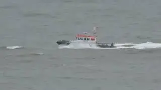 Launch boat in choppy sea off Sandy Bay near Exmouth Devon England UK on 10.11.22