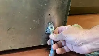 How to install a kick-down door stop on a metal door.