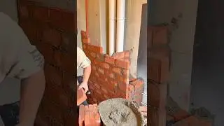 Building a sturdy brick wall with precise alignment and smooth mortar application technique