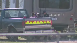 Man hospitalized, schools under secure status after shooting, suspect at large, officials say