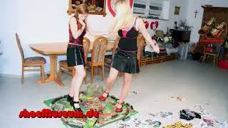 Quarrel 2 - two young women destroy a toy train set with Mary Jane shoes