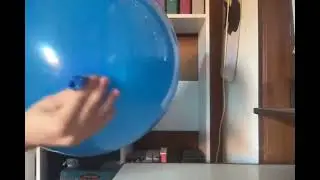 Blowing up a big blue balloon