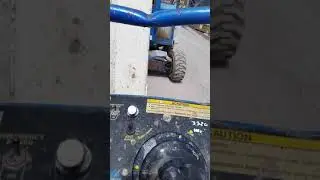 Genie S-40 Man lift moving to next location to continue working