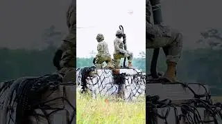 Female soldiers attach logistics to a CH-47 helicopter