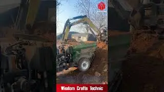 Mini Excavator Loads Manure Spreader: Efficient Muck Loading Operation