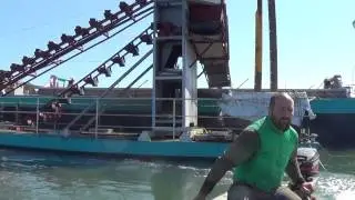Bucket Chain Dredging channels split hopper barge in Ria Formosa lagoon Faro, Algarve, Portugal