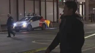 Woman trapped under driverless car after hit-and-run