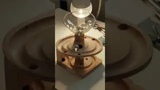 AI ASMR: Clear glass marbles softly cascading through intricate wooden marble run
