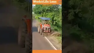 Compact tractor with front dozer blade clears roadside vegetation, soil for safety and maintenance.