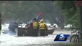 Damon Lane rides along with firefighters trying to save people from floodwaters
