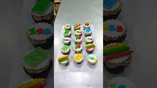 The image displays a batch of cupcakes decorated with school-themed toppers.❤️❤️❤️❤️