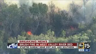 Brush fire burning in west Valley river bed
