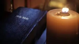 Candle next to The Holy Bible| Free HD Stock Footage