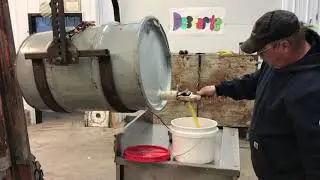Tipping and tapping a honey barrel.