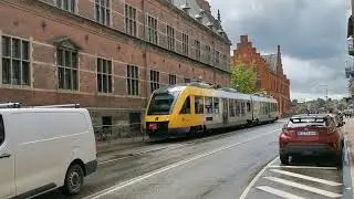 Lokaltog train running along the road in Helsing&oslash;r Denmark 