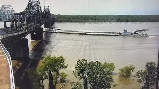 The tow Rickey Hughes makes contact with the Highway 80 Bridge.