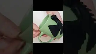 Mug with a black dragon. Night Fury Toothless Beamy Eyes How to Train Your Dragon sit on a green cup