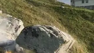 guys drop big huge stone from hill cliff into sea