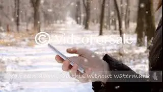 Girl holding smart phone and work on it, typing a message