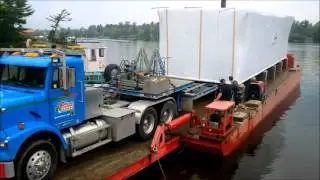 Modular Transport Canada loads a house onto a barge