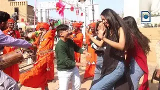 A group of young boys and girls dancing with snake-charmer
