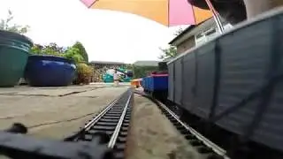 Hornby model train trip through garden