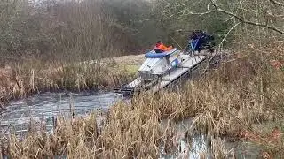 Truxor Removing Bulrush Reeds from a wildlife pond.